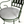 Patio chair with green metal frame and light gray upholstered seat cushion