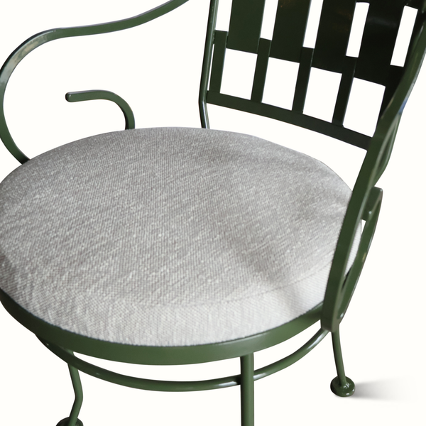 Patio chair with green metal frame and light gray upholstered seat cushion