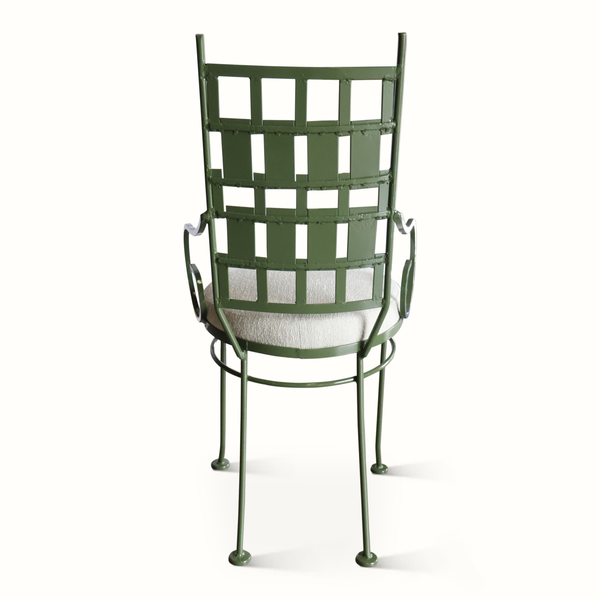 Back view of green metal patio chair with lattice panel and round cushioned seat