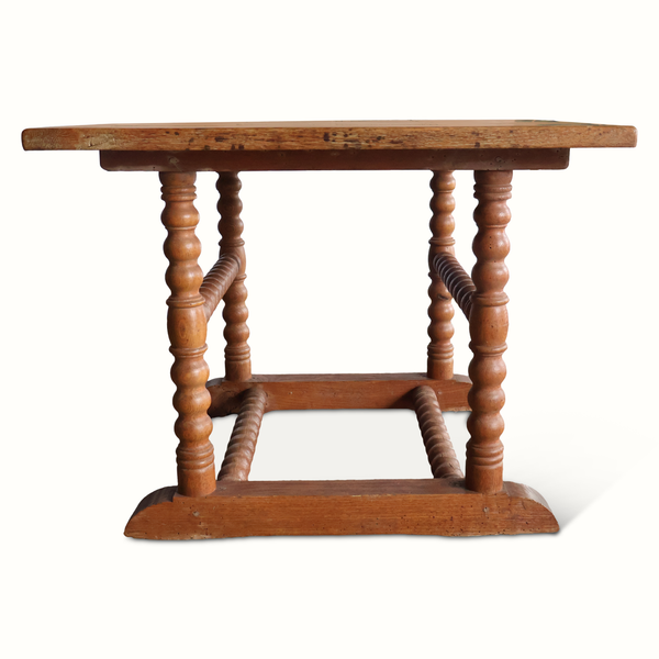 Wooden side table with turned legs and rectangular trestle stretcher