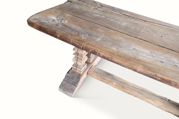 Reclaimed wood farm table showing side profile and carved turned support legs