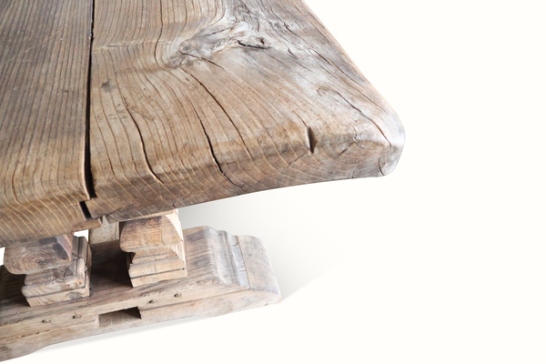 Reclaimed wood farm table corner detail with rounded tabletop end and leg joinery