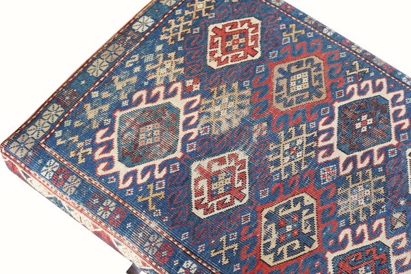Kilim carpet bench seat with red blue cream squares and cross-stitch style motifs