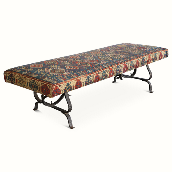 Kilim carpet bench with long seat, dark iron frame, and blue red geometric pattern