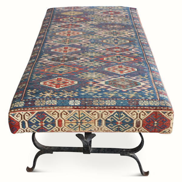 Kilim carpet bench with geometric diamond motifs, blue field, and cream border fringe