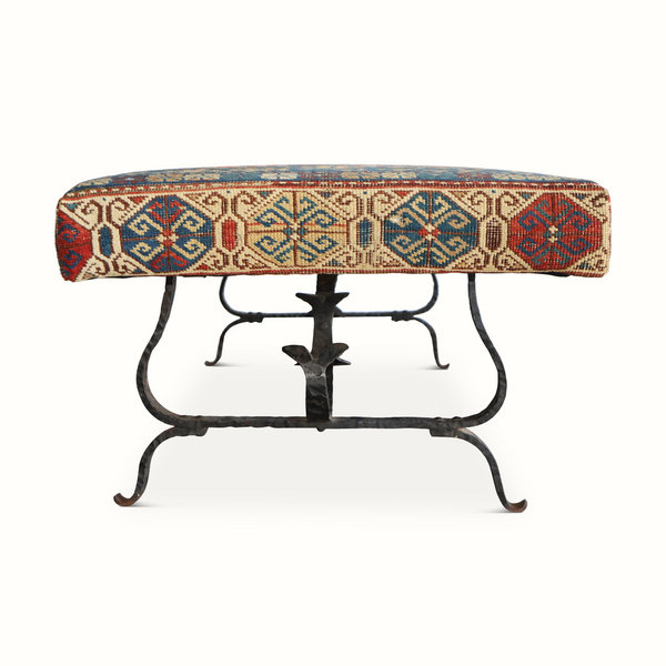 Kilim carpet bench with dark iron scroll legs and multicolor geometric woven seat