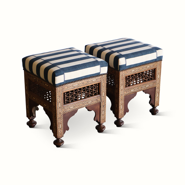 Pair of inlaid Moorish stools with striped upholstered seats and carved front panels