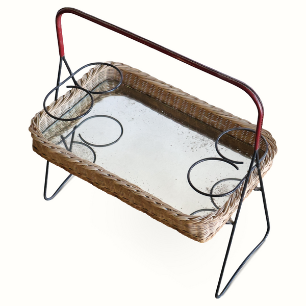 Wicker mirrored tray table with dark red leather handle bar and black iron stand, angled view