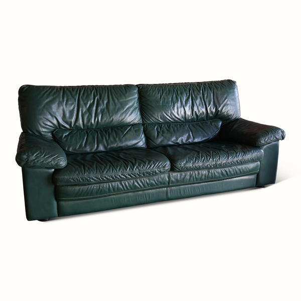 Dark green leather sofa with two-seat bench and reclined back cushions