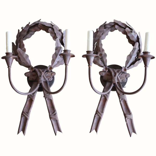 Pair of dark metal wreath wall sconces with leaf garland ring and ribbon bow accents
