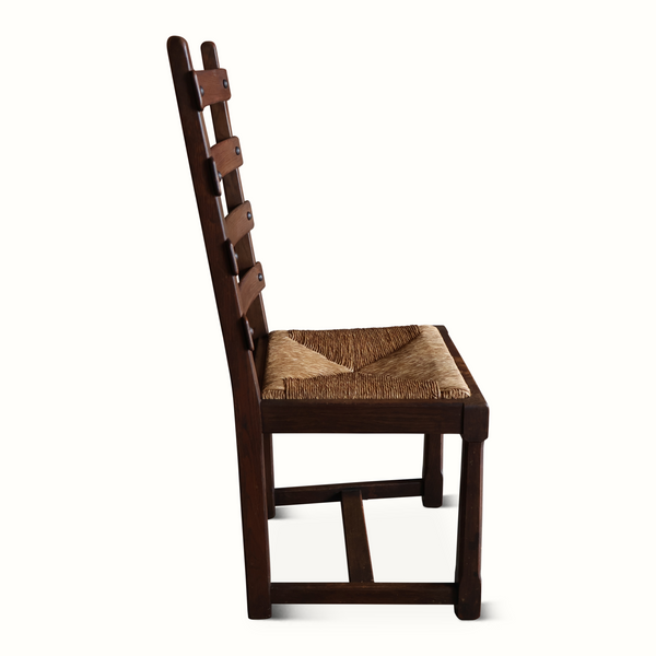 Oak ladderback chair side view with woven beige seat cushion and slatted back.