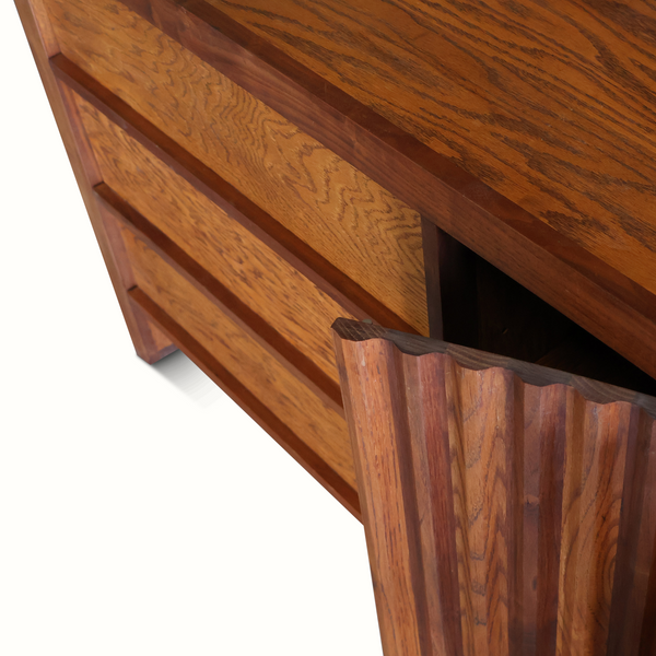 Walnut-finish dresser detail showing wood grain and open compartment edge