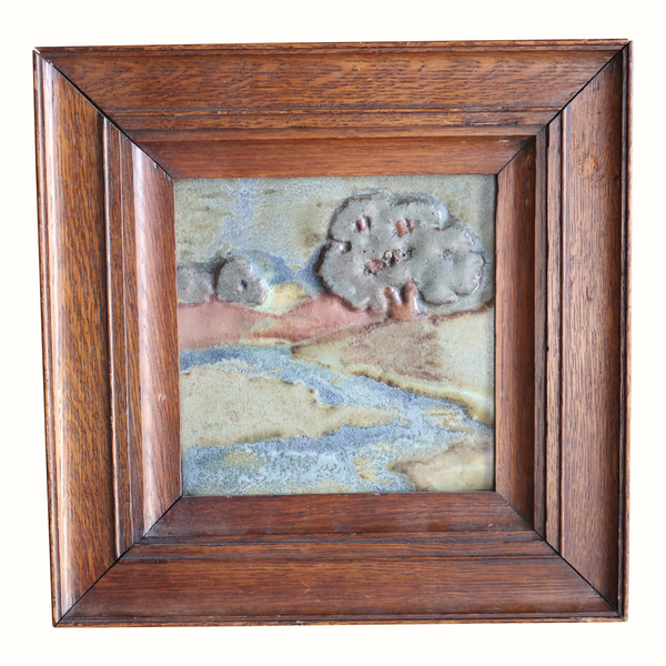 Scenic landscape pottery tile in dark wood frame, textured pastel sky, hills and water