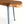 Live edge wooden side table with natural knots on rounded corner and black metal legs