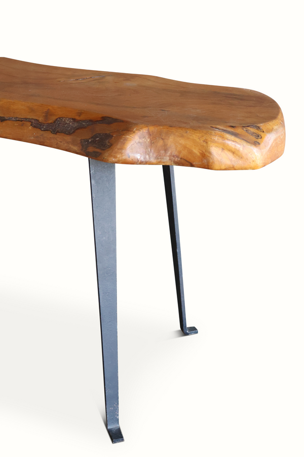 Live edge wooden side table with natural knots on rounded corner and black metal legs