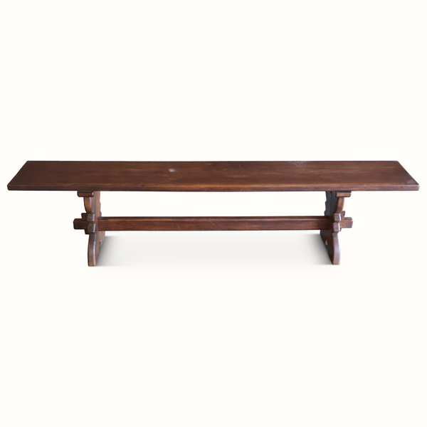 Dark brown wooden bench with straight backless seat and two central supports