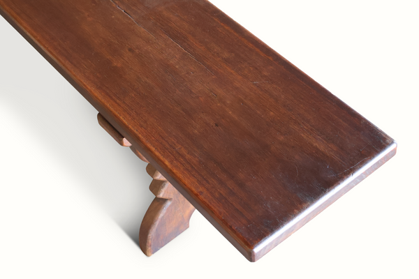 Dark brown wooden bench corner view with smooth tabletop edge