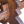 Close-up of carved wooden pedestal detail on dark brown bench