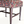Single upholstered stool corner with patterned seat, turned legs, and nailhead trim