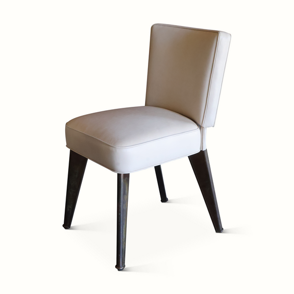 Leather accent chair with tan back and seat, dark tapered wooden legs