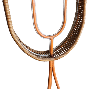 Floor lamp base close-up with woven rattan ring and dark metal and wooden tubes