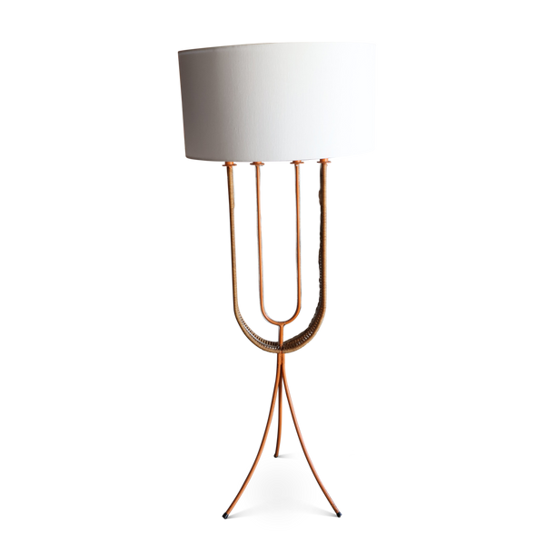 White fabric shade floor lamp with U-shaped rattan frame and tripod stand