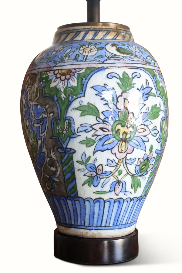 Blue and white floral ceramic vase lamp with green leaves, dark base, brass stem