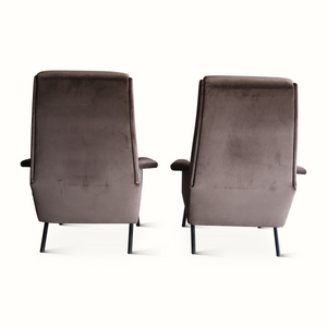 Pair of upholstered velvet armchairs shown from back with padded backrests and legs