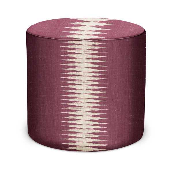 Indoor round upholstered pouf with burgundy fabric and off-white ikat pattern