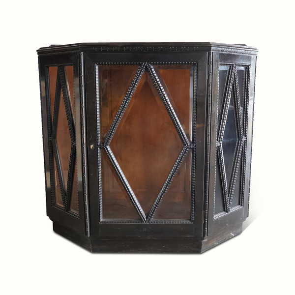 Dark wood vitrine cabinet with faceted glass door panels and diamond metal lattice