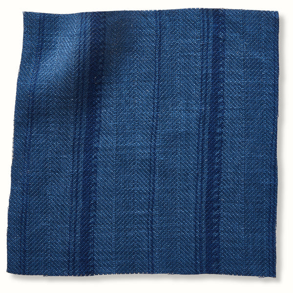 Indigo blue woven textile fabric swatch with subtle vertical stripe texture