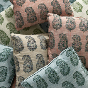 Outdoor pillows with mint green, pink, and dark paisley patterns