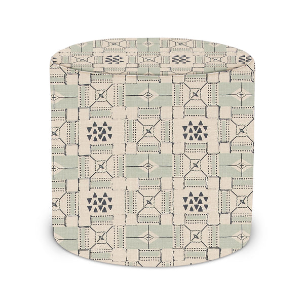 Indoor pouf with round top, beige base and indigo geometric pattern upholstery