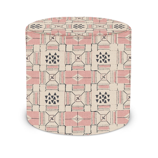 Indoor pouf with pink and indigo geometric upholstery, rounded sides and flat top
