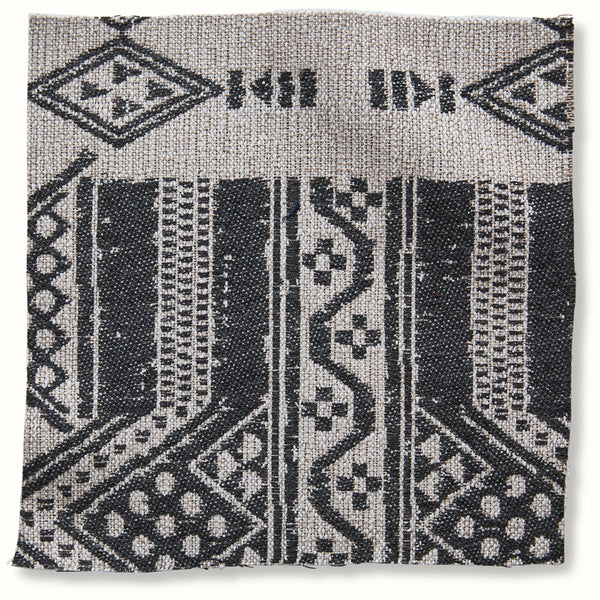 Outdoor throw pillow with geometric onyx-and-natural patterned cover
