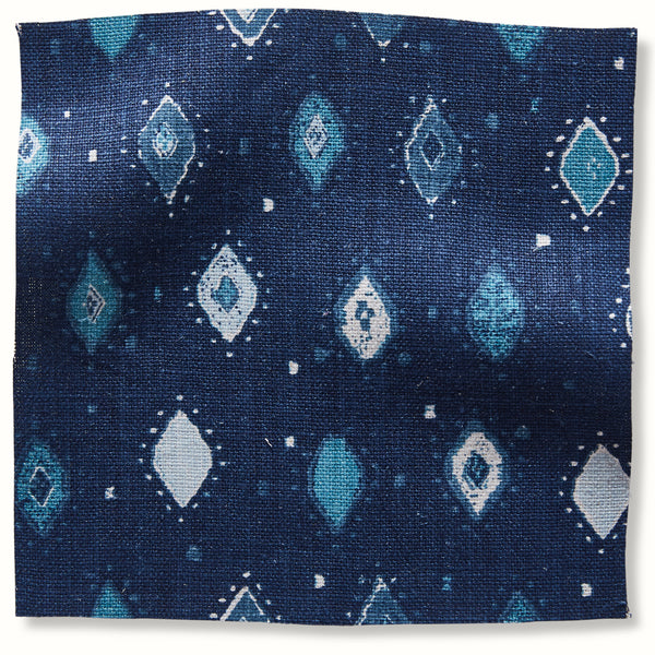 Blue geometric patterned fabric square swatch with diamond and teardrop motifs