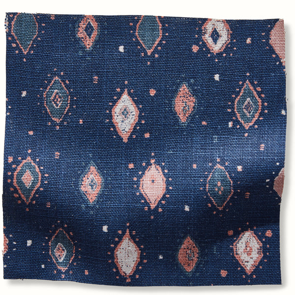 Geometric patterned pillow cover in blue with pink diamond motifs