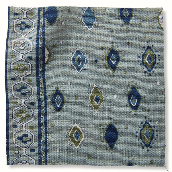 Oona throw pillow with blue geometric motifs and indigo border trim, ocean fabric