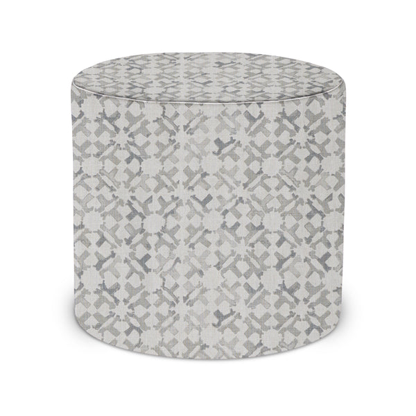 Round upholstered indoor pouf with light gray geometric pattern and fabric upholstery