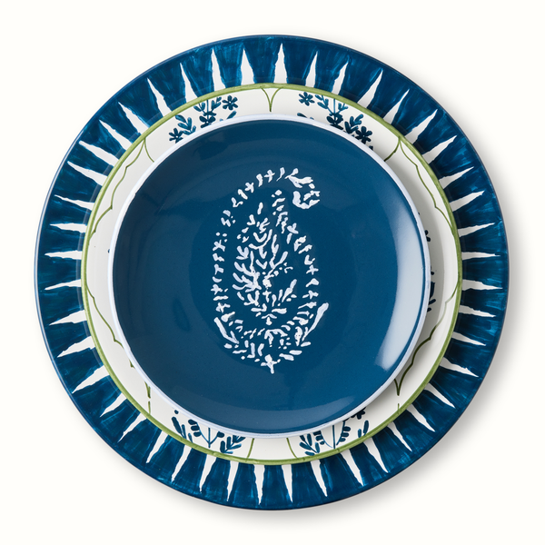 Indigo blue appetizer plate with white motif, surrounded by blue sunburst rim