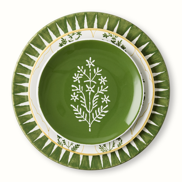 Green appetizer plate with white tree branch design, nested inside patterned outer plate
