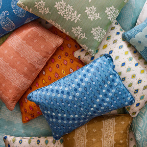 a pile of colorful, patterned pillows