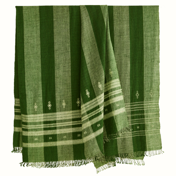 Fern green Indian bedcover draped over bed with vertical stripes and fringed border
