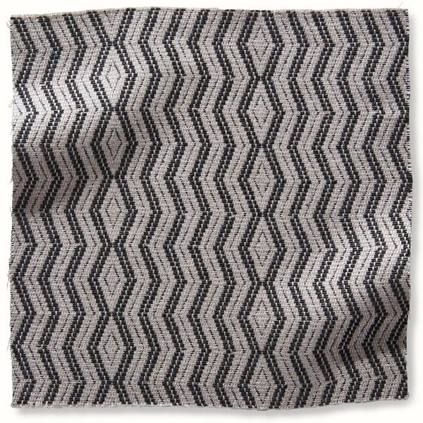 Outdoor pillow cover with charcoal chevron pattern on natural base