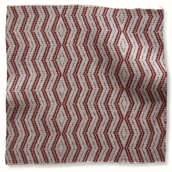 Outdoor pillow cover with red and natural geometric diamond pattern, woven texture