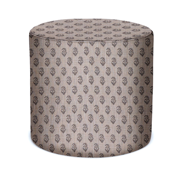 Round upholstered indoor pouf in ash-gray with repeating motif fabric, flat top.