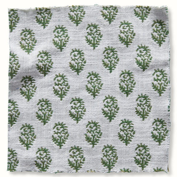 Outdoor pillow cover with white base and green pear motif pattern, textured weave.