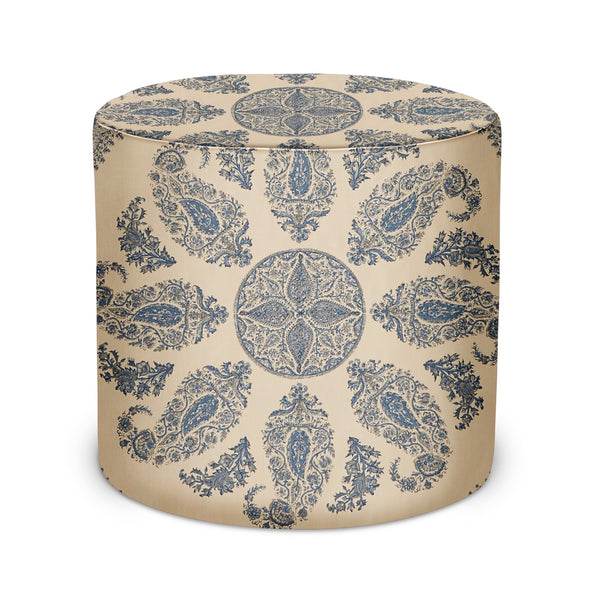 Indoor pouf with blue paisley pattern on beige fabric, round cushioned top