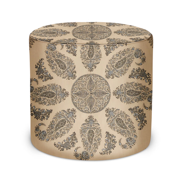 Round upholstered pouf with charcoal-toned paisley medallion print, fabric cover.