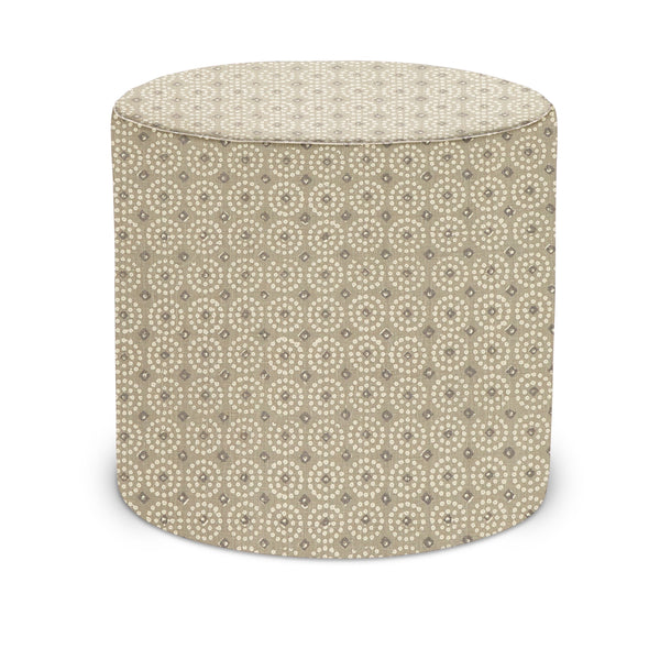 Indoor pouf with light beige fabric and repeating circular pattern, rounded top and sides